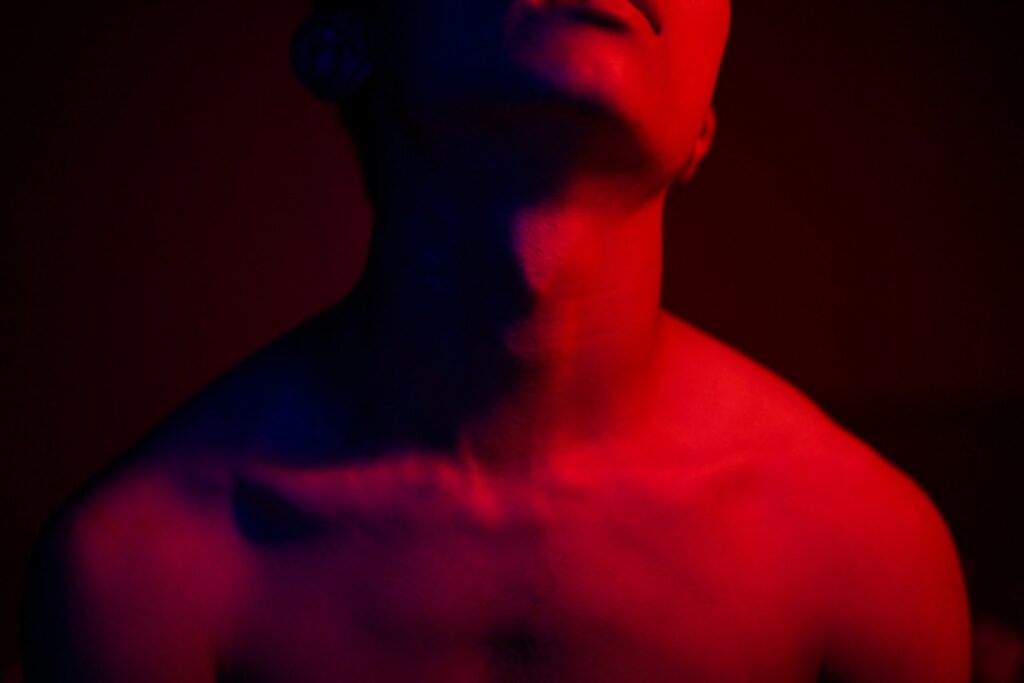 topless man with red light on his back
