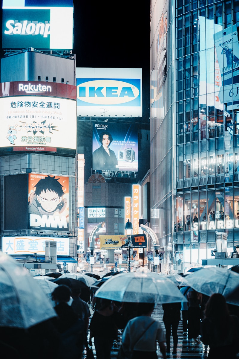 Nighttime in a bustling, neon-lit city street.