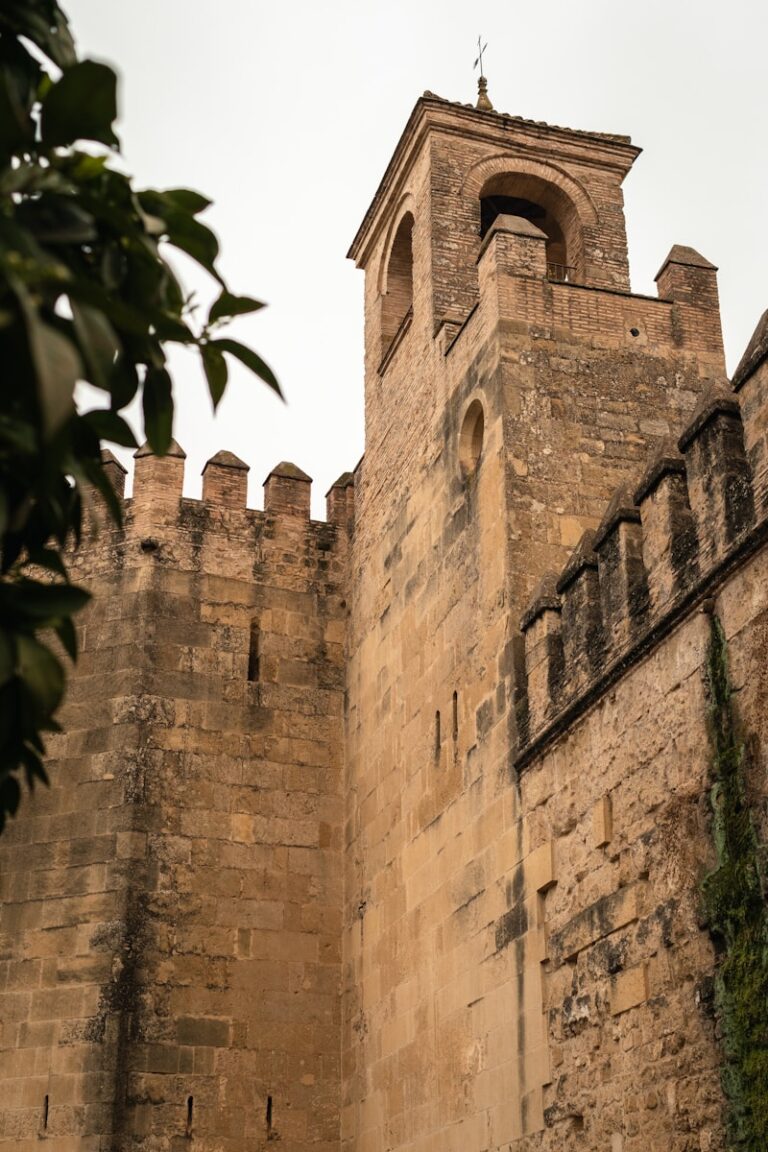 a tall brick building with a clock on it's side